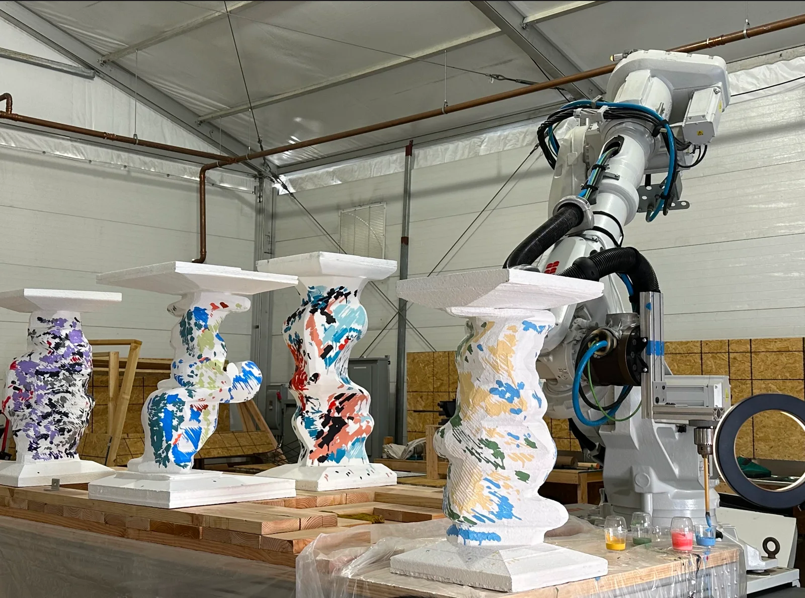 Four finished columns next to the robot